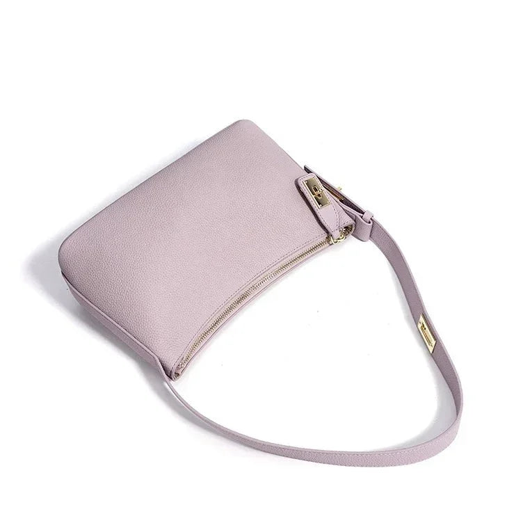 Light purple leather shoulder bag with gold zipper and hardware on white background