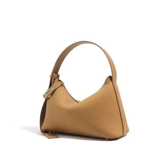 Tan leather hobo handbag with gold buckle on a white background