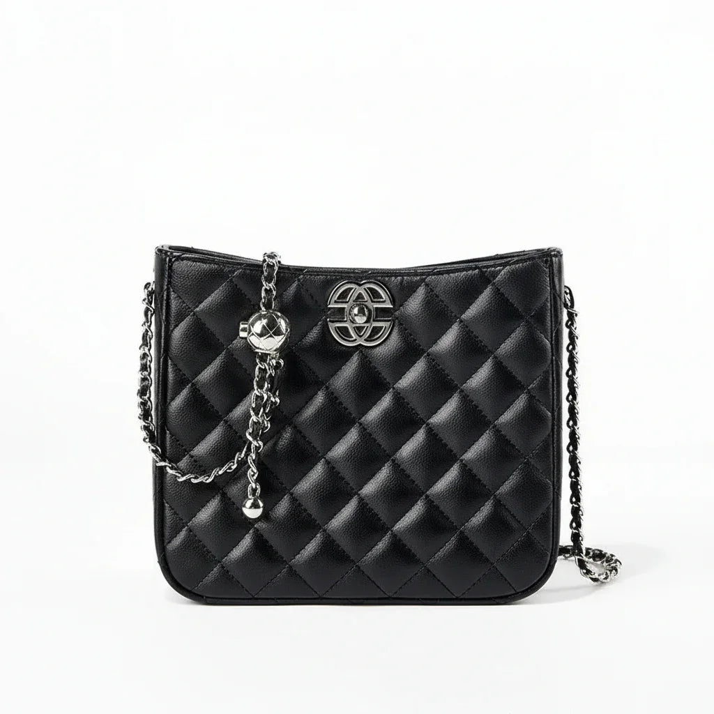 Black quilted leather crossbody bag with silver chain strap and metal logo on white background