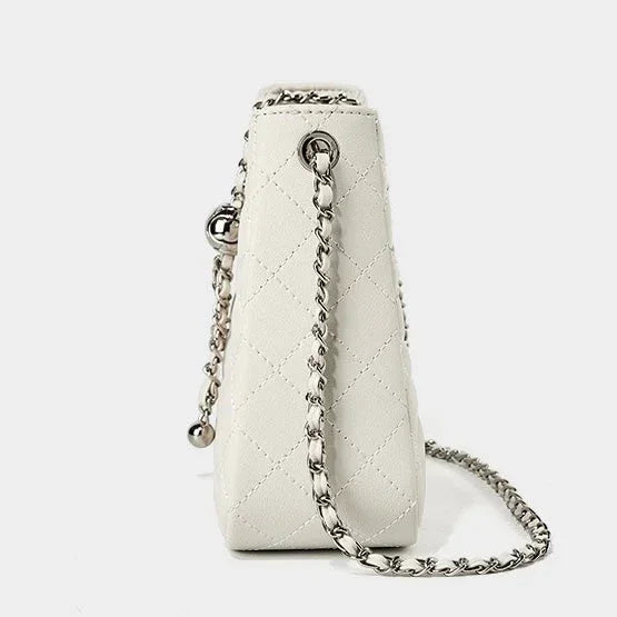 White quilted leather handbag with silver chain strap on white background