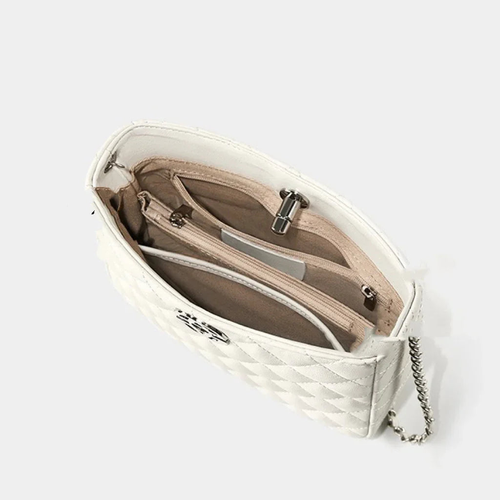 White quilted handbag with chain strap and beige interior pockets, top view