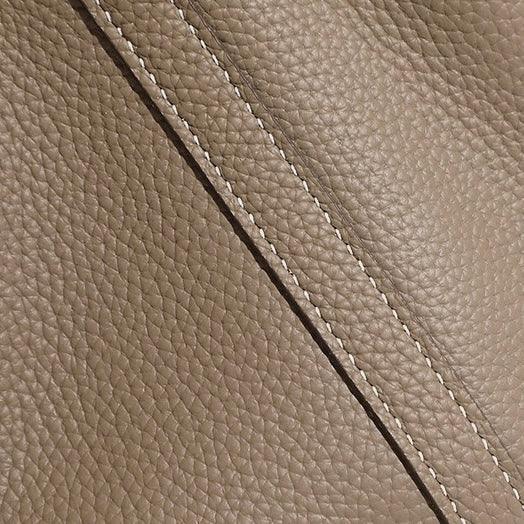Textured taupe leather with diagonal stitching, close-up luxury material detail