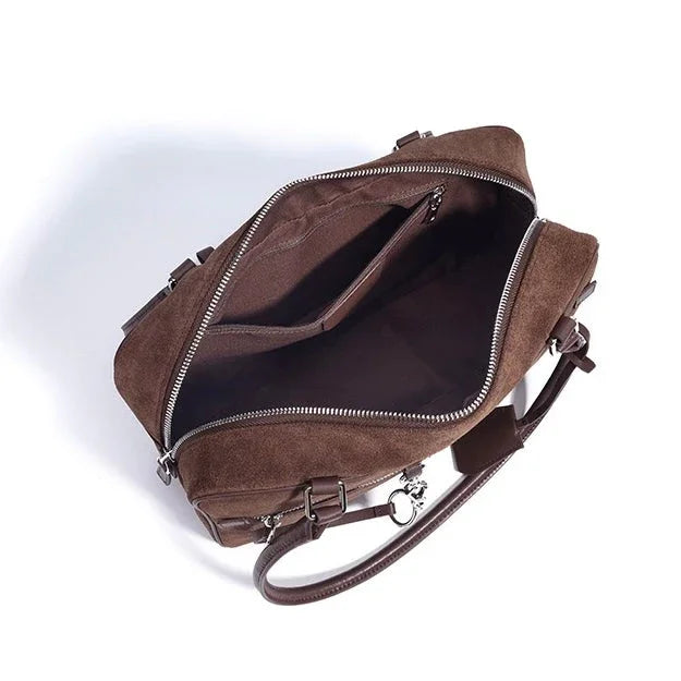 Open brown suede leather laptop bag with zipper, shoulder strap, and internal pocket