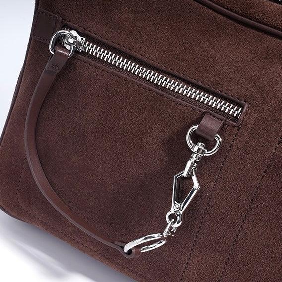 Brown suede handbag with silver zipper and leather strap detail