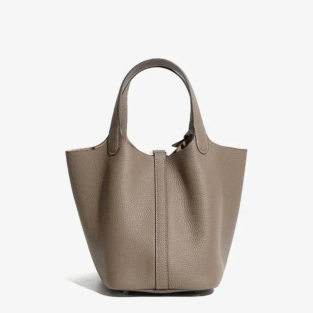 Taupe leather tote bag with pebbled texture and double handles on white background