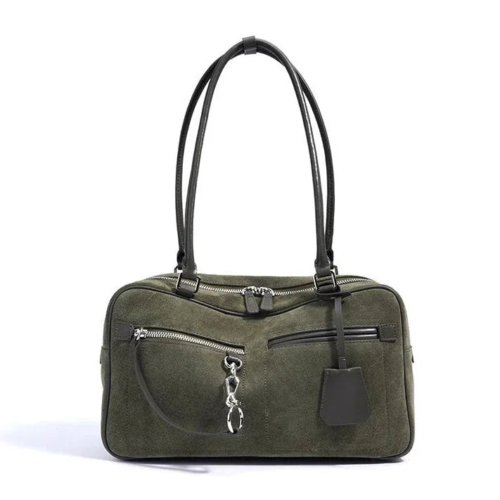 Olive green suede handbag with black leather handles and silver zippers