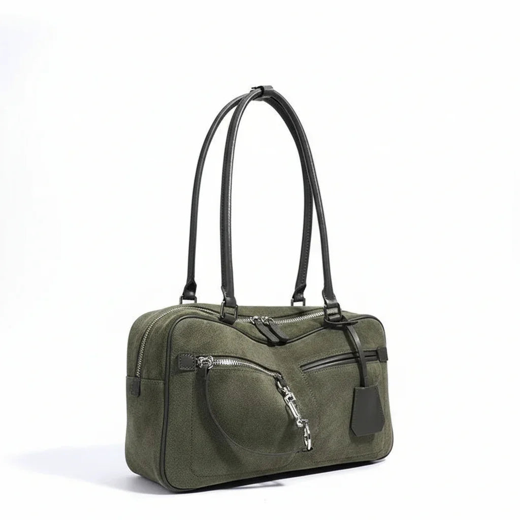 Olive green suede handbag with dual black leather straps and silver zipper accents
