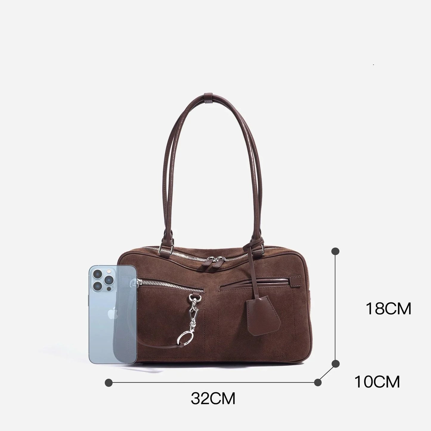 Brown suede handbag with double handles, silver zippers, 32x18x10cm, next to a smartphone