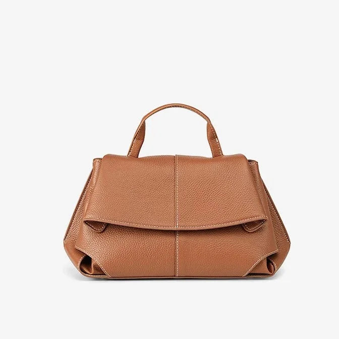 Brown leather handbag with top handle against white background