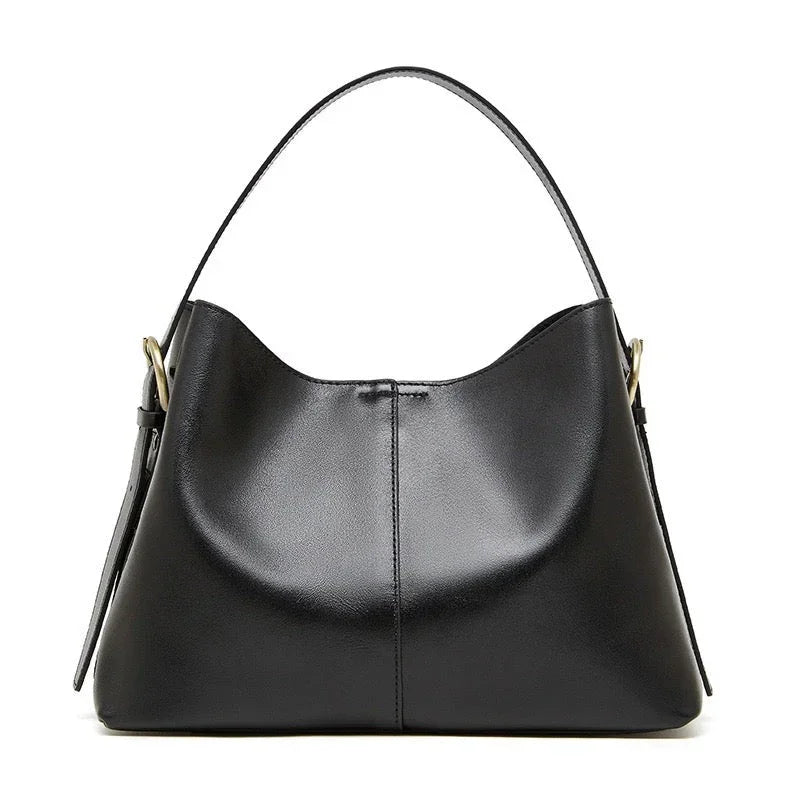 Black leather hobo handbag with gold hardware on white background