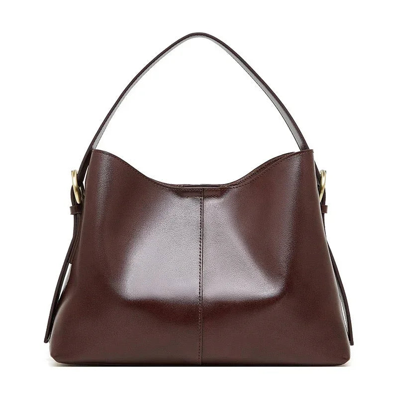 Brown leather hobo handbag with gold hardware on a white background