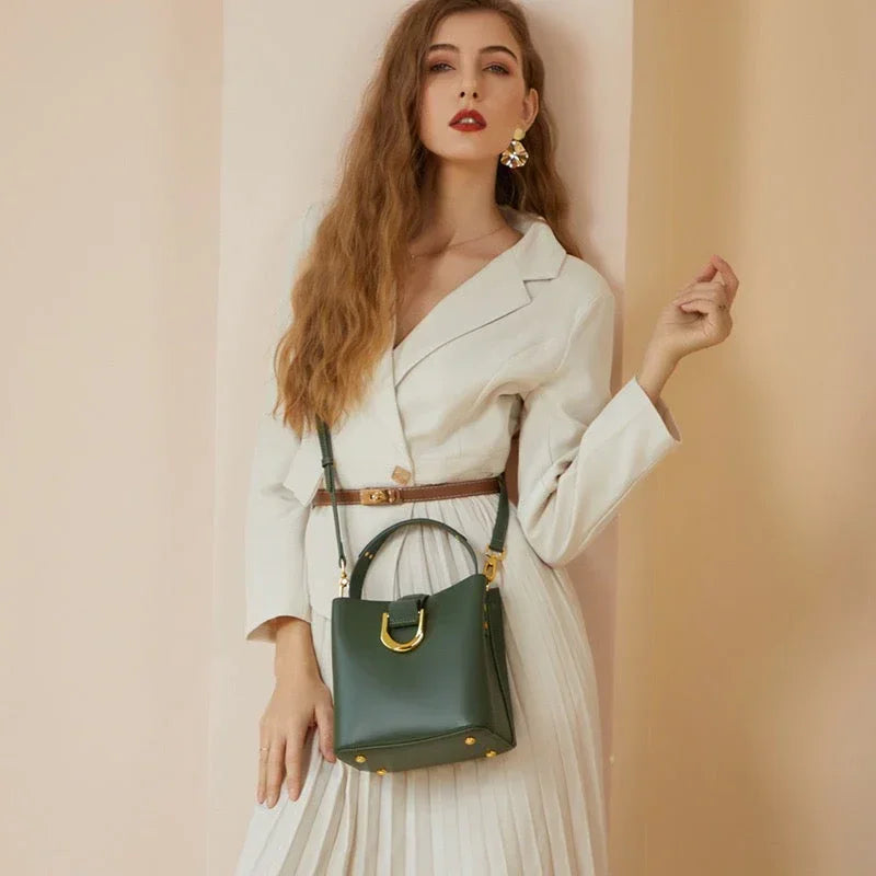 Woman in white dress with brown belt and green leather handbag, fashion photoshoot