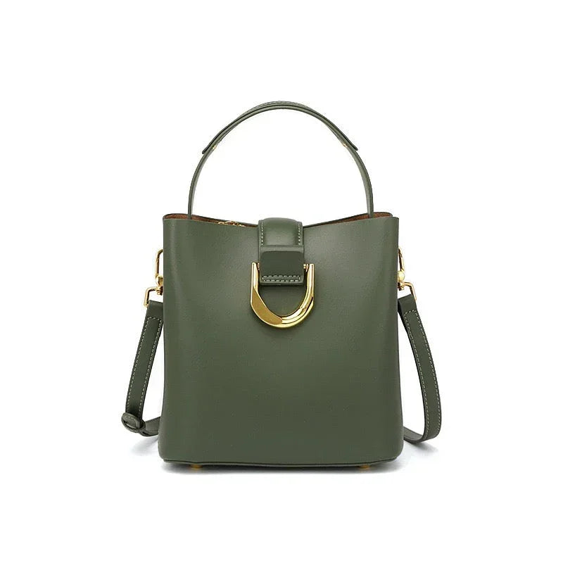 Olive green leather handbag with gold buckle, top handle, and detachable strap on white background