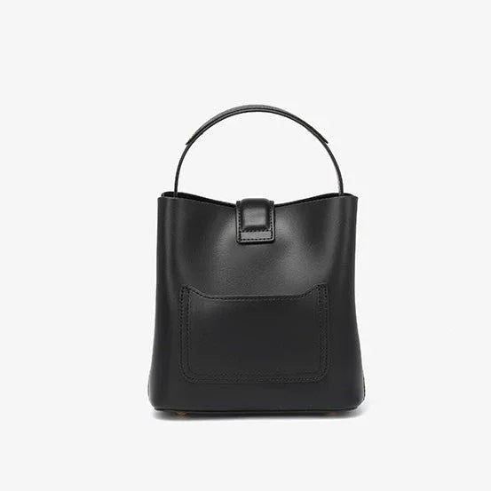 Black leather bucket bag with top handle and front pocket on white background