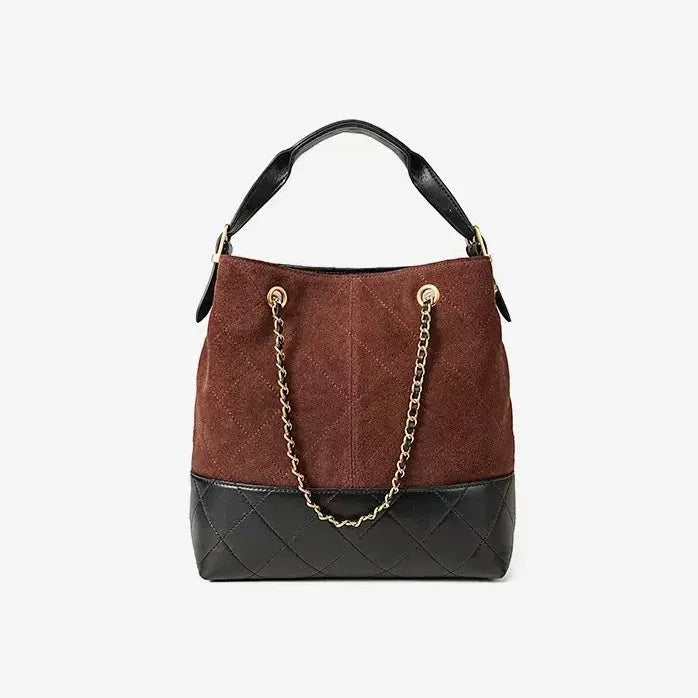 Two-tone brown and black suede bucket bag with gold chain strap and quilted leather base
