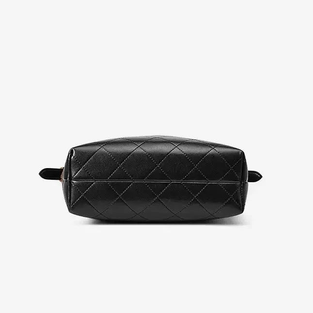Black quilted leather bag with diamond stitching on a white background