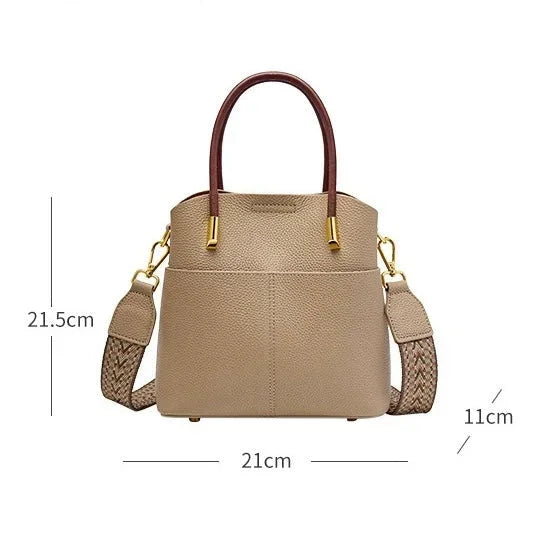 Beige leather handbag with brown handles, gold hardware, braided strap, and size dimensions
