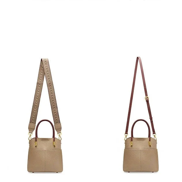 Taupe leather handbags with two different detachable shoulder straps on white background