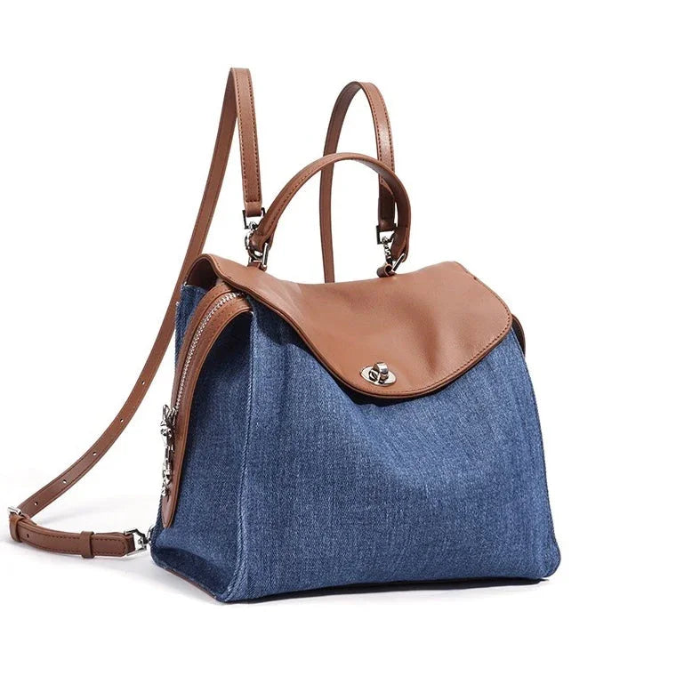 Blue denim backpack with brown leather flap and adjustable shoulder straps