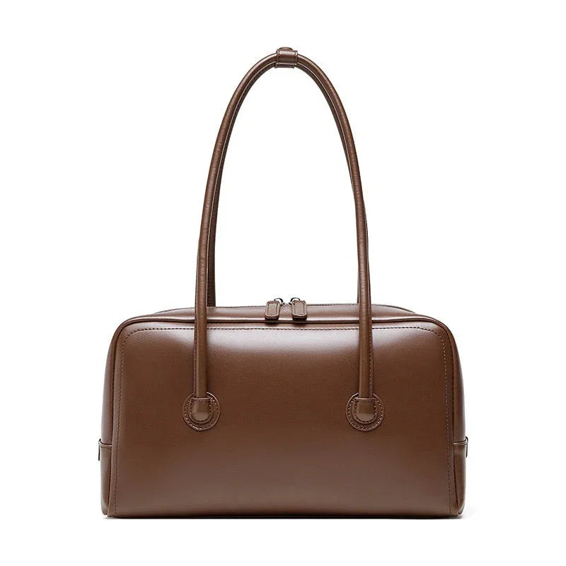 Brown leather handbag with double handles on white background