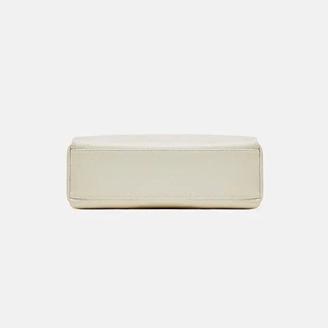 Beige rectangular leather bag bottom view on white background