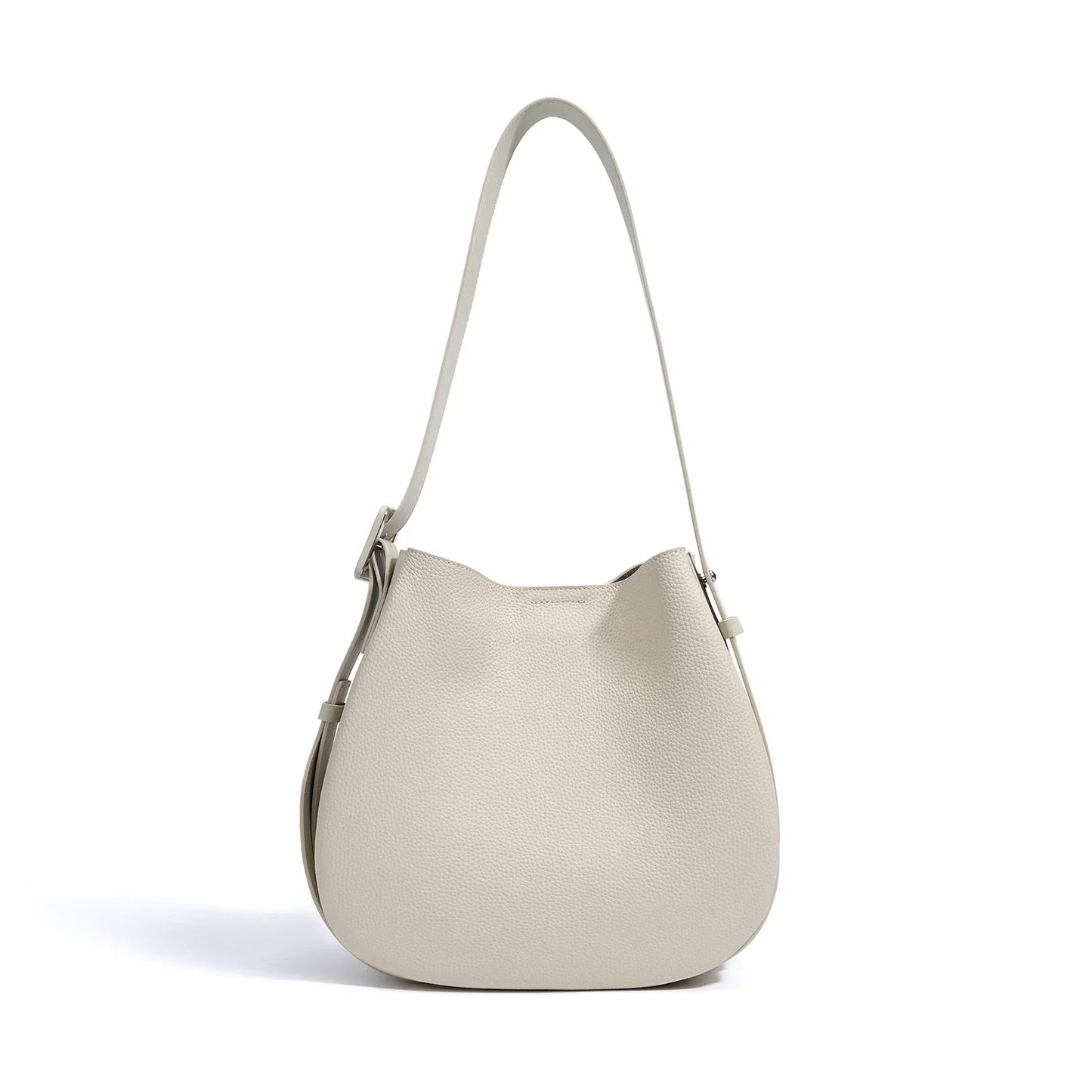 Beige leather shoulder bag with adjustable strap on white background