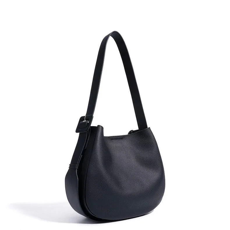 Black leather shoulder bag with adjustable strap on white background