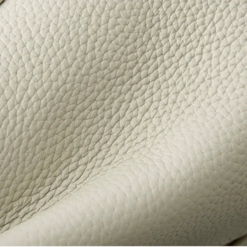 Close-up of textured cream leather upholstery with natural grain pattern