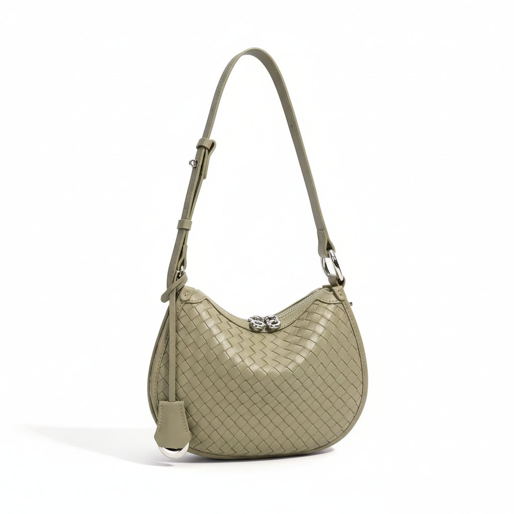 Woven leather shoulder bag in sage green with adjustable strap and silver clasp, product photo
