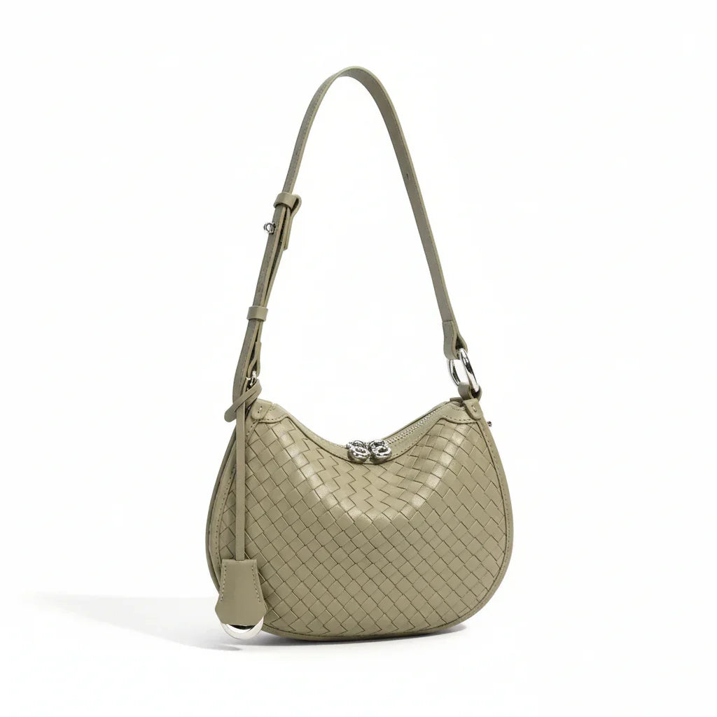 Woven leather shoulder bag in sage green with adjustable strap and silver clasp, product photo