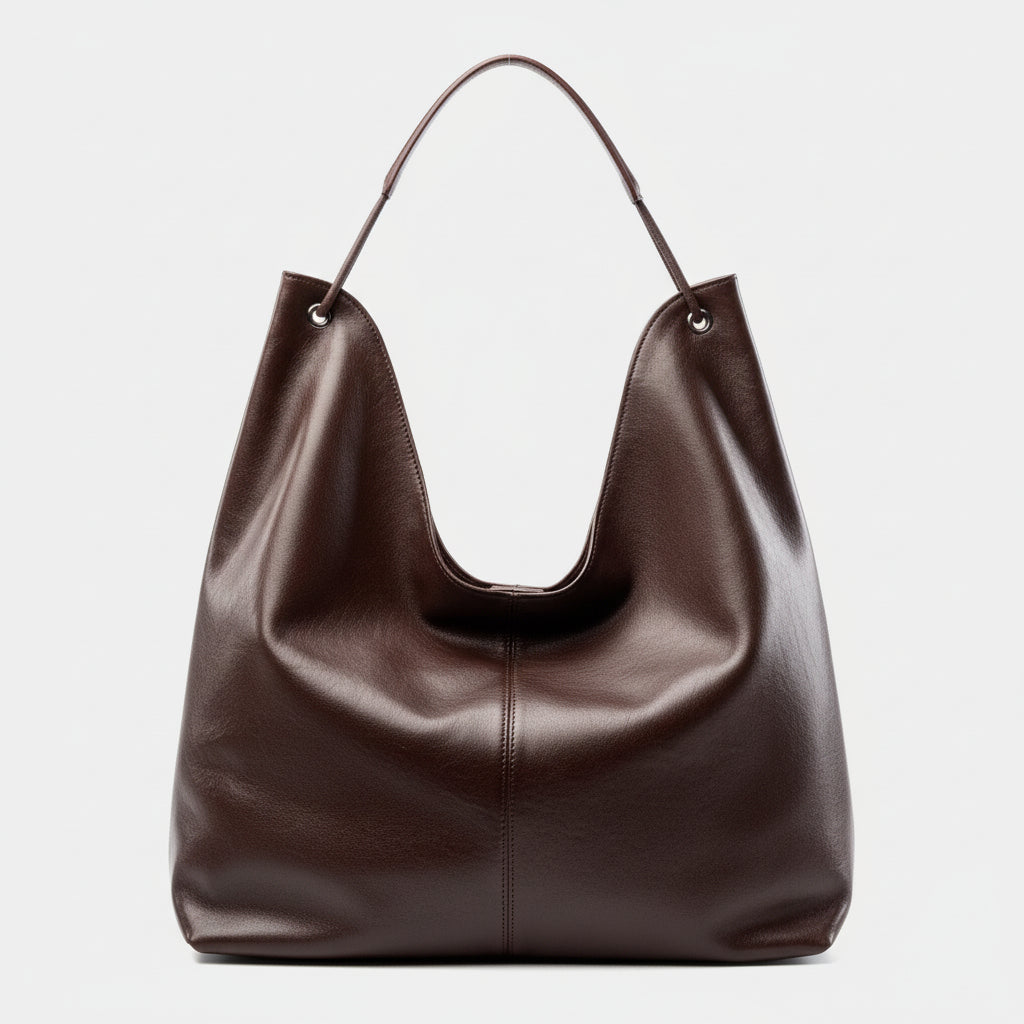 Brown leather hobo bag with a single handle on a plain white background