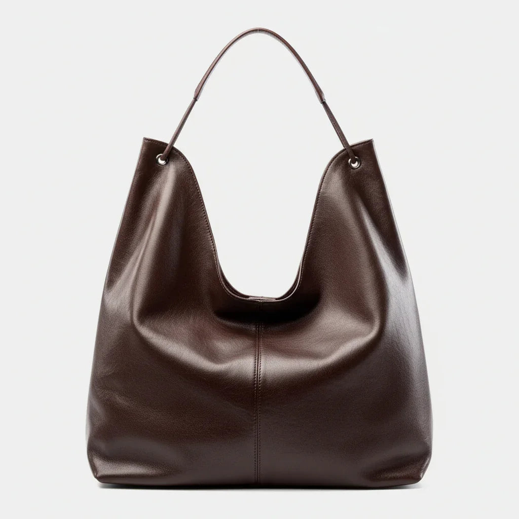 Brown leather hobo bag with a single handle on a plain white background