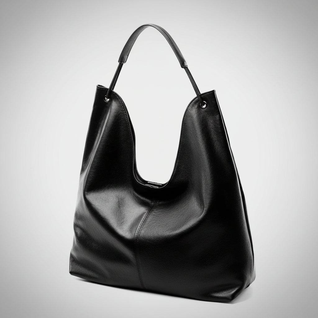 Black leather hobo bag with shoulder strap on plain white background