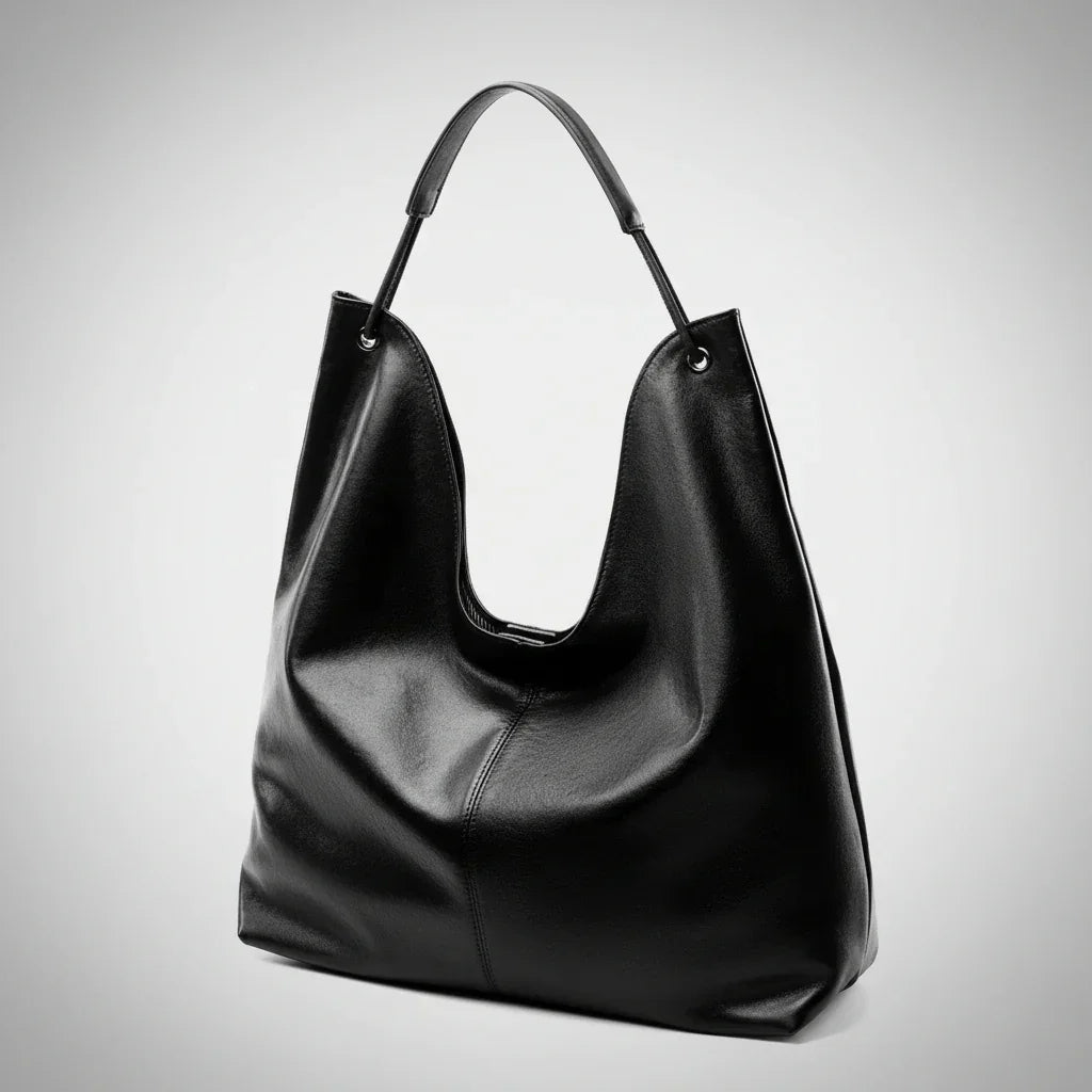 Black leather hobo bag with shoulder strap on plain white background