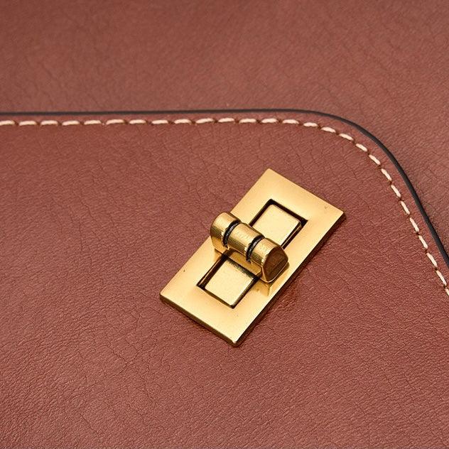 Brown leather bag with gold turn lock closure and white stitched edge