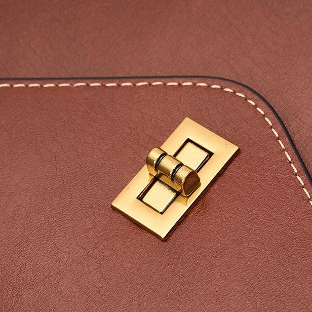 Brown leather bag with gold turn lock closure and white stitched edge