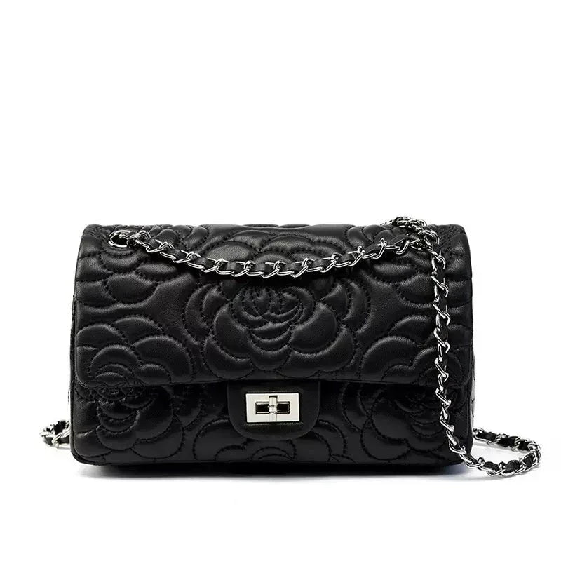 Black quilted leather shoulder bag with floral pattern and silver chain strap