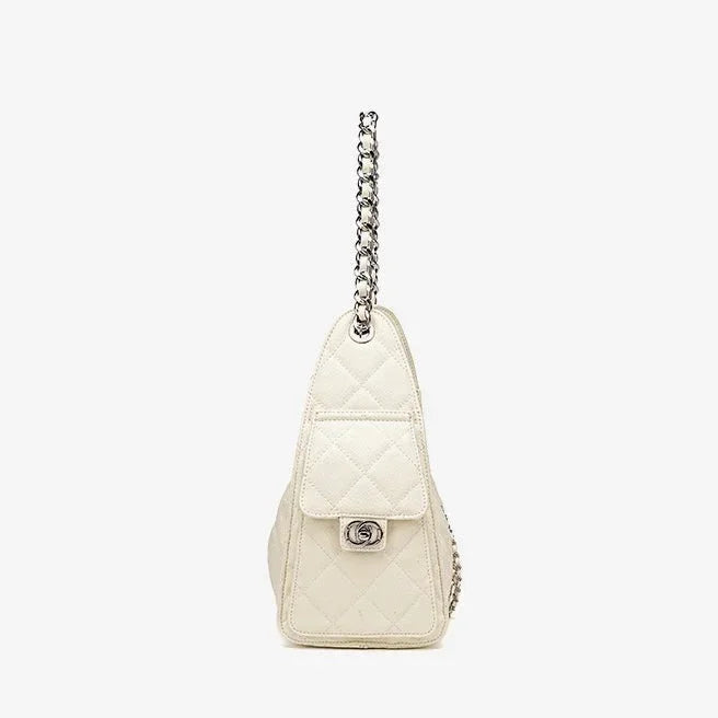 Side view of a quilted white leather handbag with silver chain strap and turn-lock closure