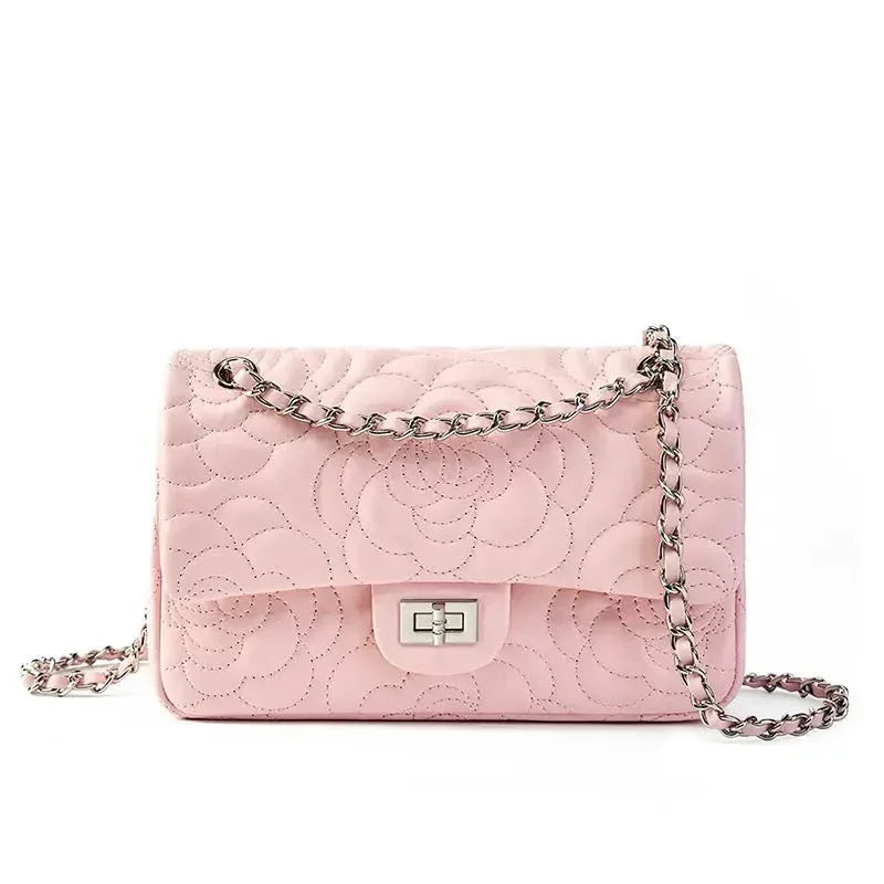 Light pink quilted shoulder bag with floral pattern and silver chain strap