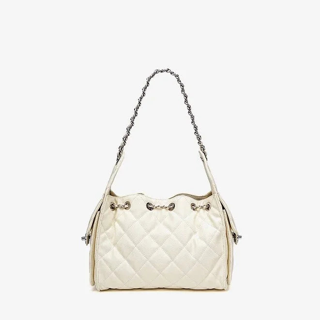 Quilted white leather shoulder bag with silver chain strap on white background