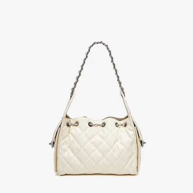 Quilted white leather shoulder bag with silver chain strap on white background