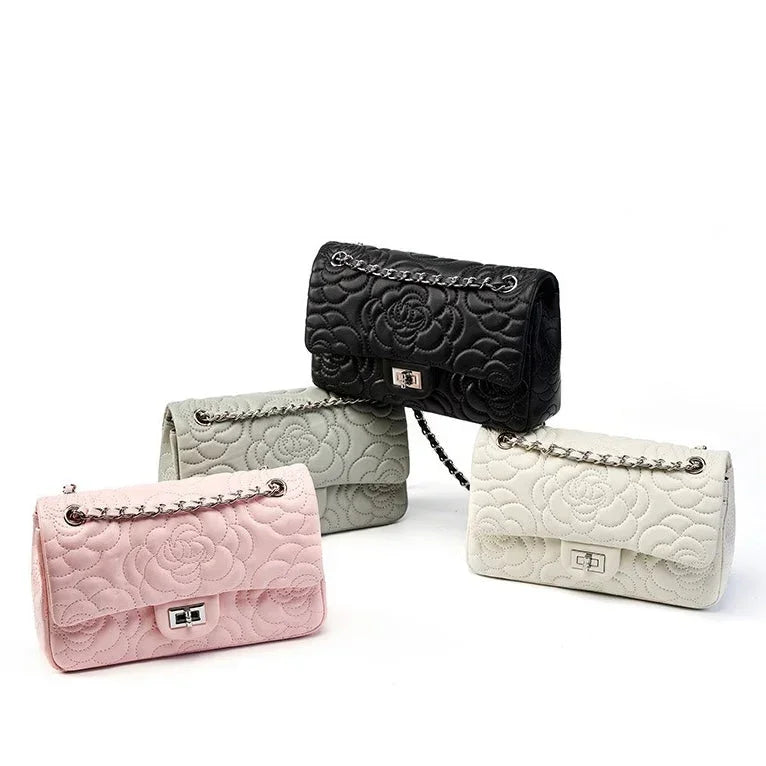Quilted leather handbags in black, gray, pink, and white with floral patterns and chain straps