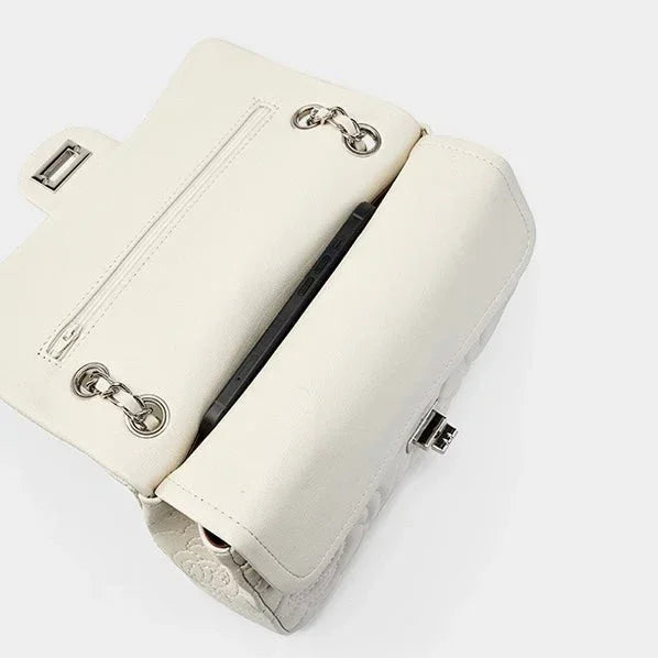 Open white leather purse with silver hardware and a visible interior pocket