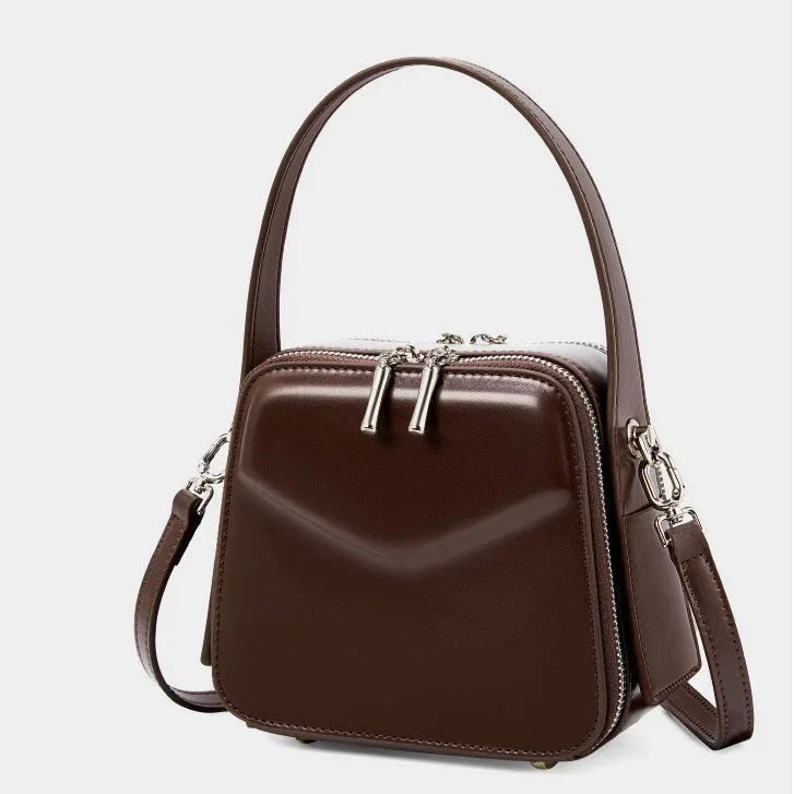 Brown leather square handbag with top handle, silver hardware, and detachable strap