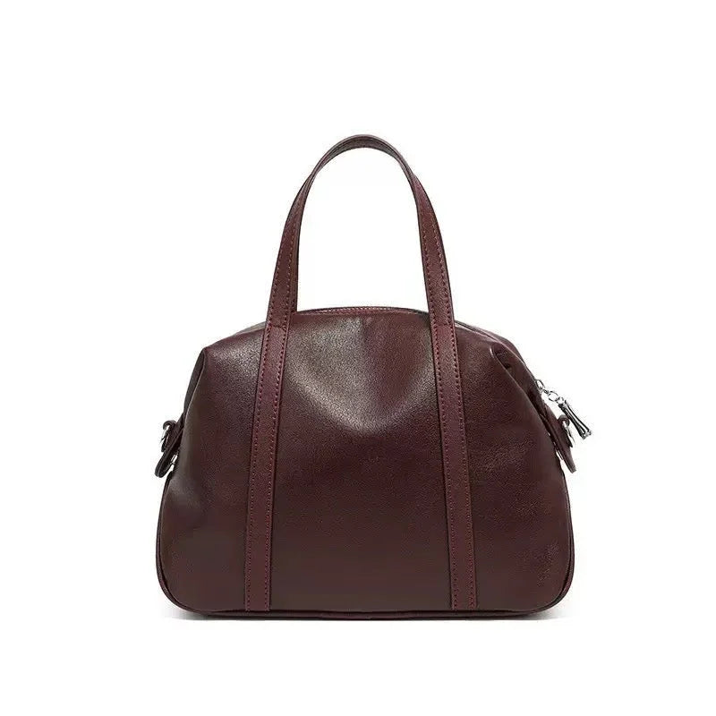 Elegant dark brown leather handbag with double handles on a white background