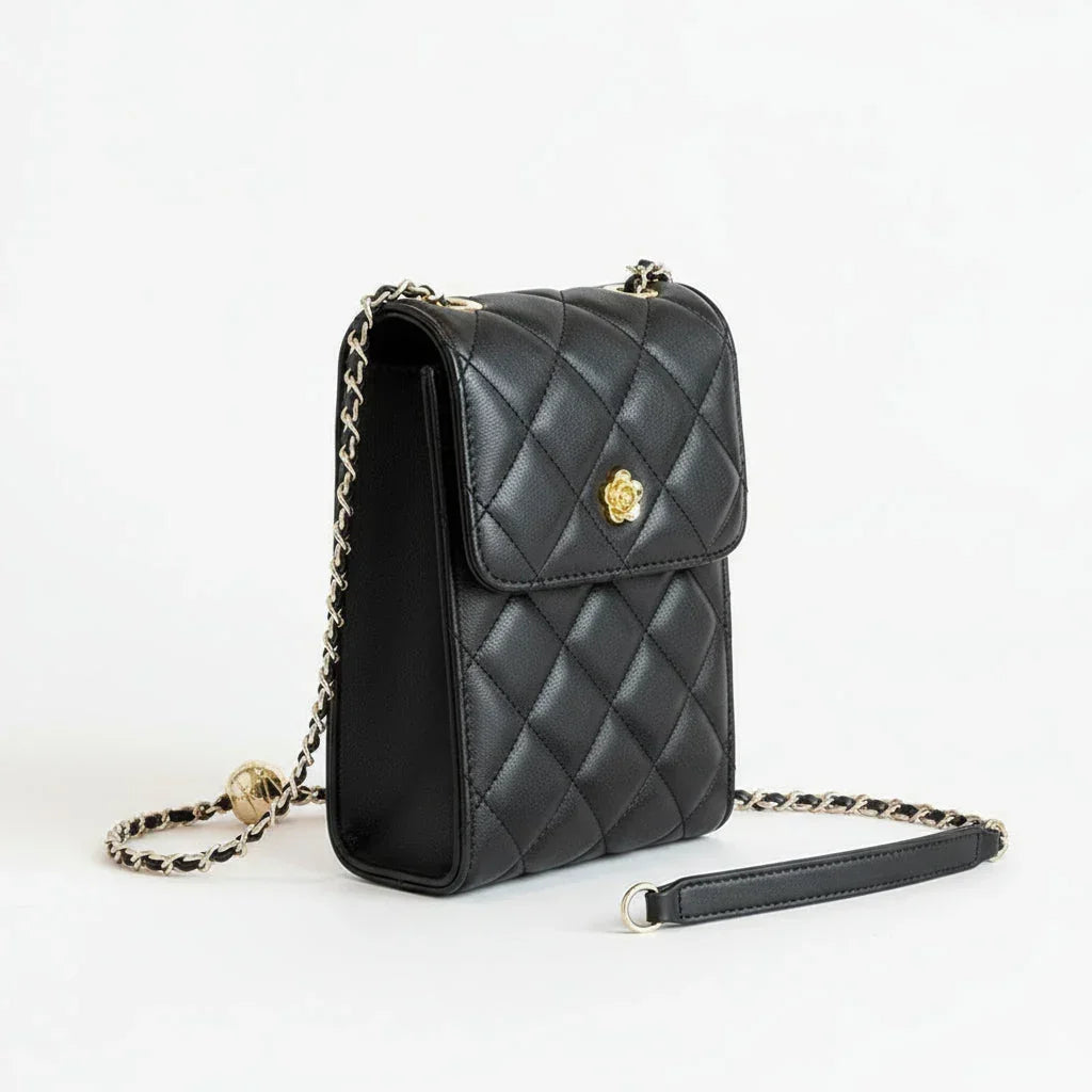 Quilted black leather crossbody purse with gold chain strap on white background