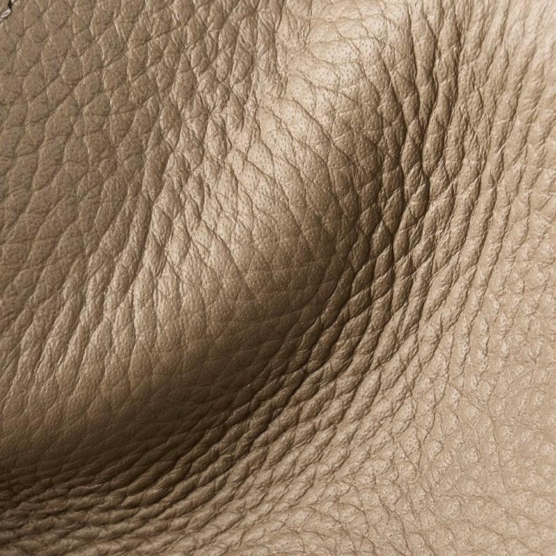 Close-up of textured brown leather surface with natural grain and creases