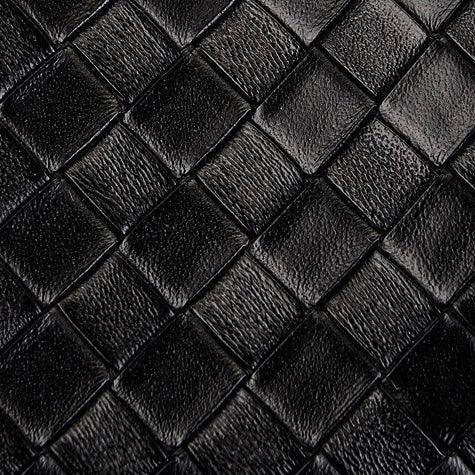 Black woven leather texture with diamond pattern, luxury fashion material close-up