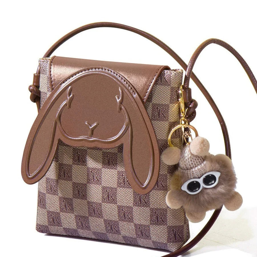Brown checkered crossbody bag with bunny face design and plush keychain accessory