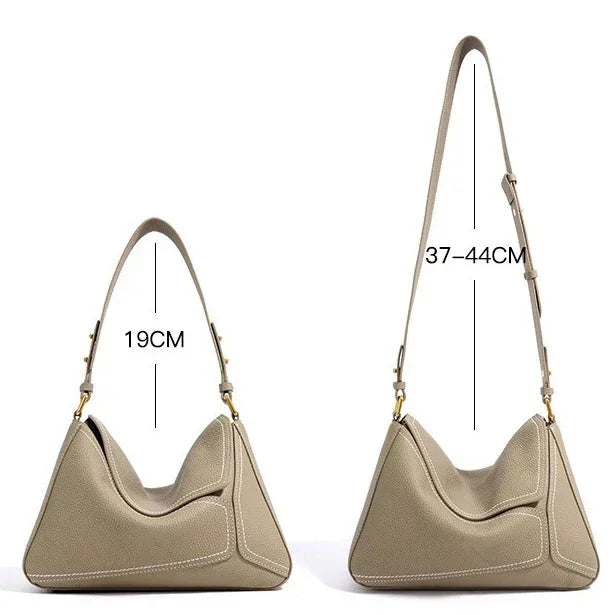Beige leather handbag with two adjustable straps, 19cm and 37-44cm long, side by side.
